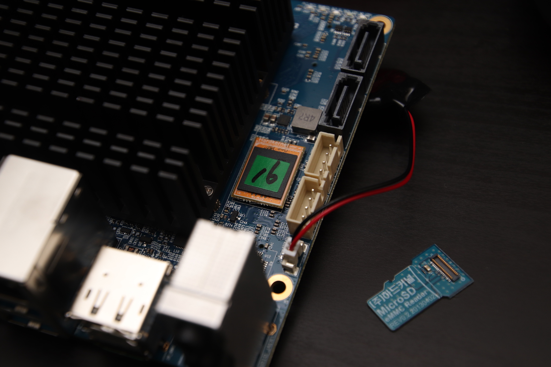 Closeup of the eMMC mounted on the device, next to the dual SATA ports, and the reader for the chip sitting next to it.